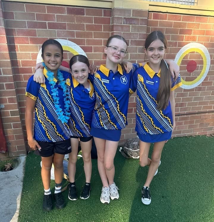 Students posing together celebrating the warm Maitland Public School community and learning environment.